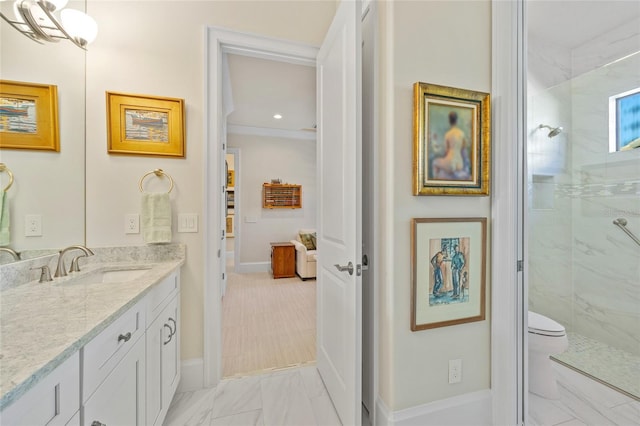 full bathroom with toilet, marble finish floor, vanity, and a walk in shower
