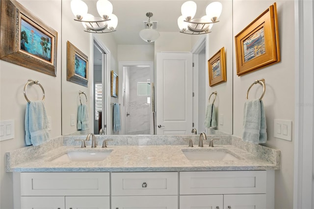bathroom with an inviting chandelier, a stall shower, visible vents, and a sink