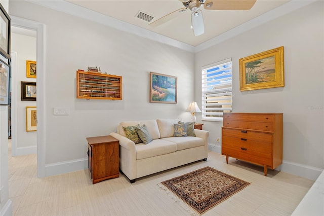 sitting room with visible vents, baseboards, crown molding, and a ceiling fan
