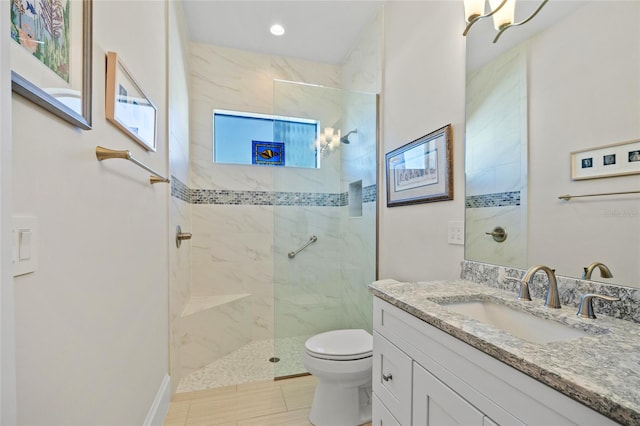 bathroom featuring toilet, vanity, and a walk in shower