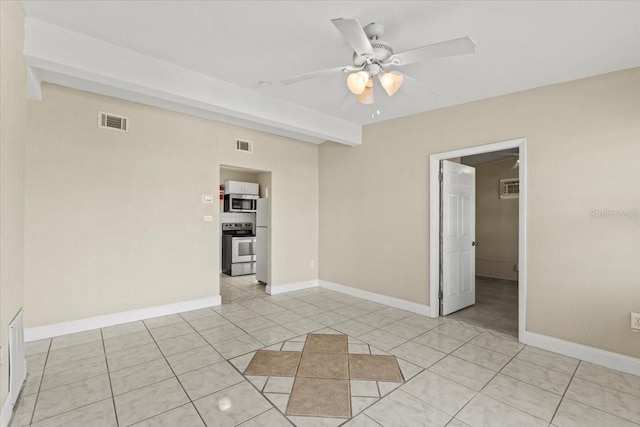 empty room featuring light tile patterned floors, baseboards, visible vents, and ceiling fan