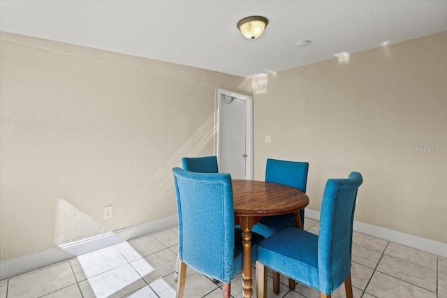 tiled dining room with baseboards