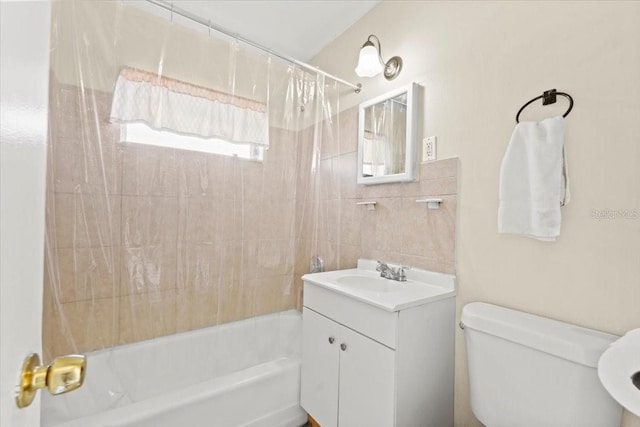 bathroom with shower / bath combo with shower curtain, toilet, and vanity