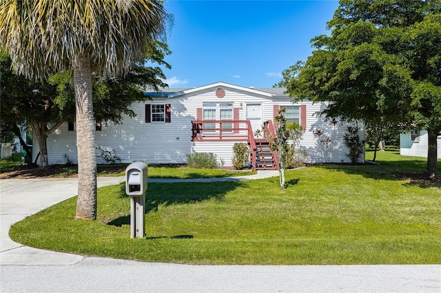 view of front of house with stairway and a front yard