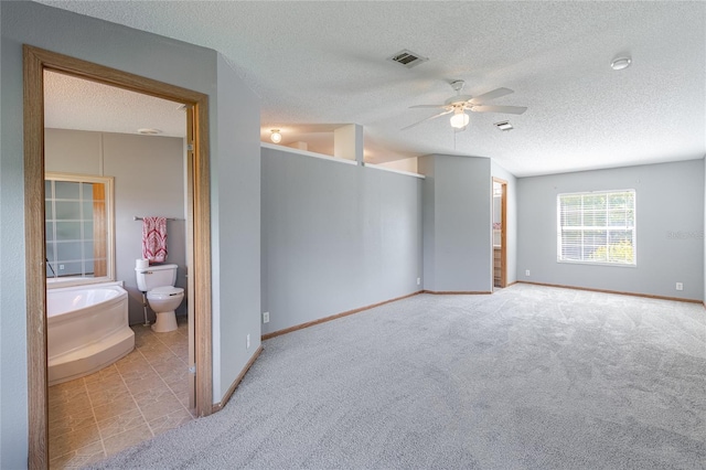 unfurnished bedroom with visible vents, connected bathroom, and carpet floors