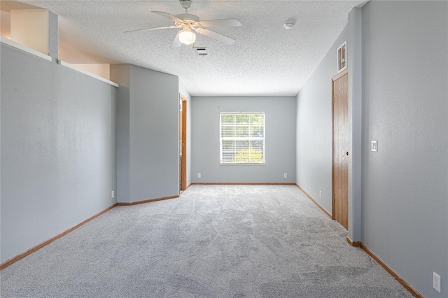 unfurnished bedroom featuring carpet flooring, baseboards, and a textured ceiling