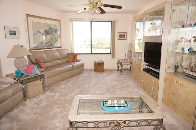 carpeted living area featuring a ceiling fan