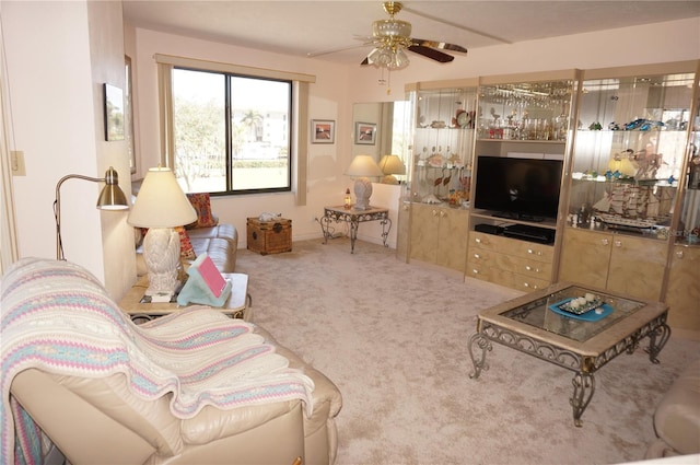 carpeted living room with ceiling fan