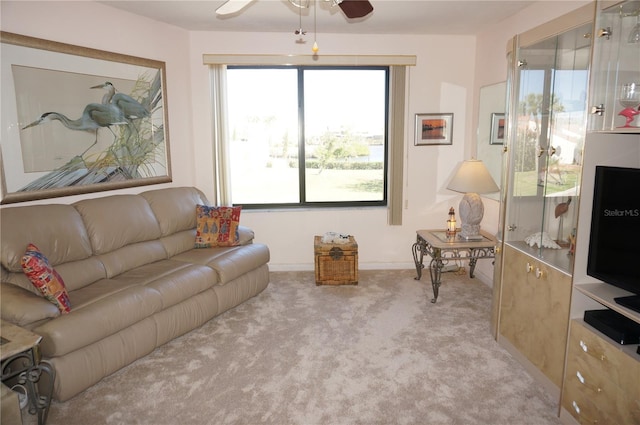 living room featuring light colored carpet and ceiling fan