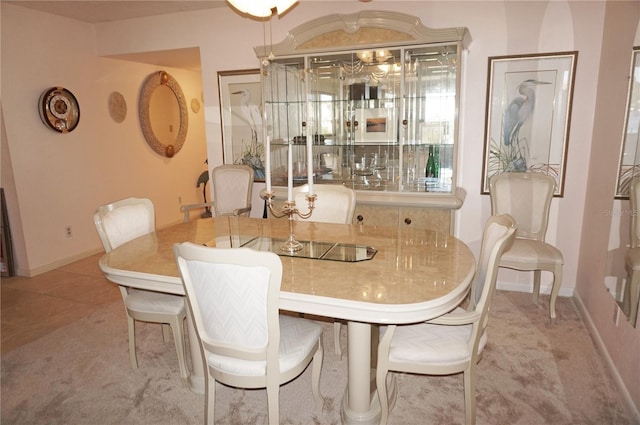 dining space featuring tile patterned floors and baseboards