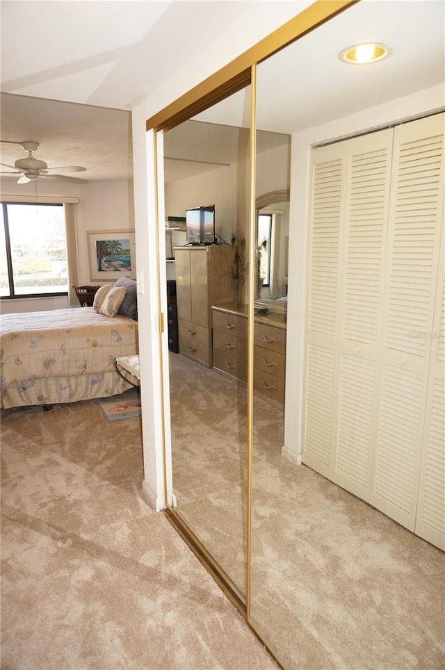 bathroom with ensuite bath, a closet, and ceiling fan