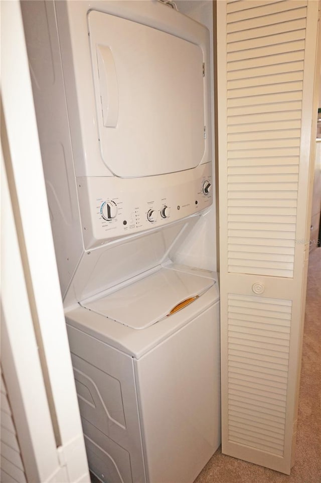 laundry area with laundry area and stacked washer / drying machine