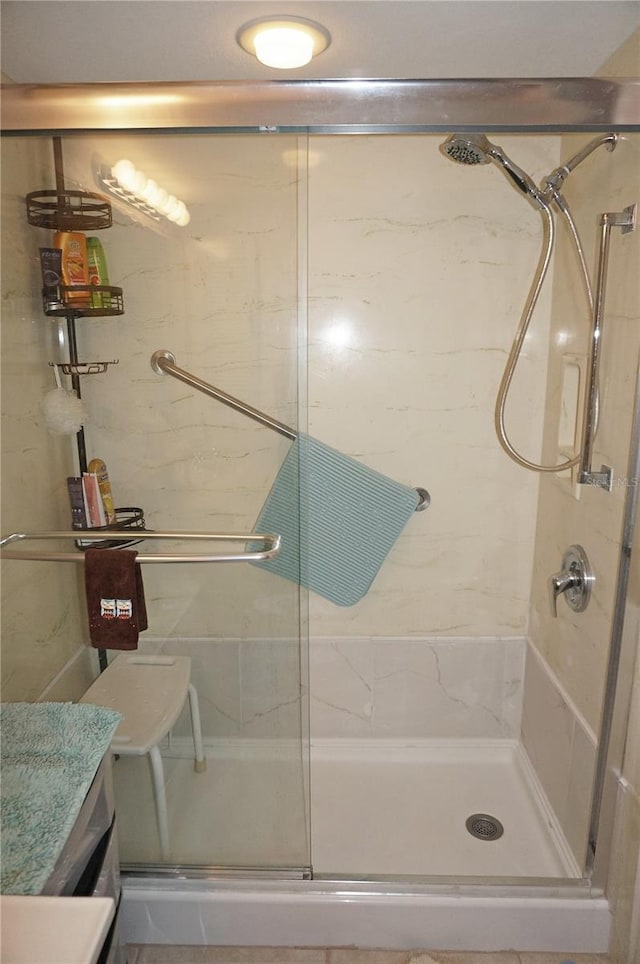 full bath featuring vanity and a shower stall