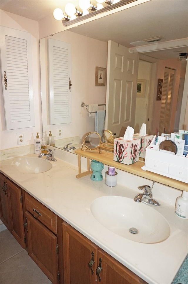 bathroom with tile patterned flooring, double vanity, and a sink