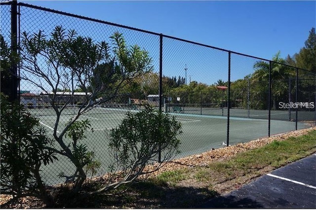 view of tennis court with fence