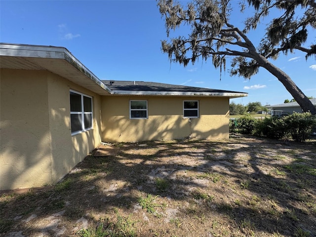 view of side of property with stucco siding