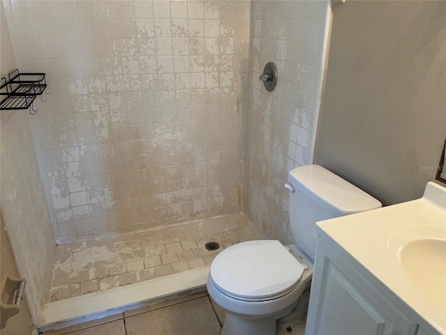 bathroom featuring toilet, a stall shower, and vanity