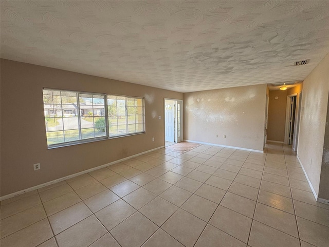 30147 Holly Rd, Punta Gorda, FL 33982 - spare room featuring baseboards, a textured ceiling, visible vents, and light tile patterned floors