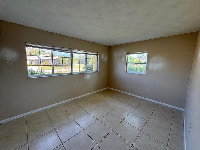30147 Holly Rd, Punta Gorda, FL 33982 - empty room featuring baseboards and light tile patterned floors