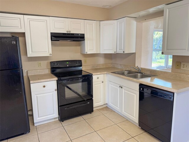 30147 Holly Rd, Punta Gorda, FL 33982 - kitchen with white cabinetry, light countertops, under cabinet range hood, a sink, and black appliances