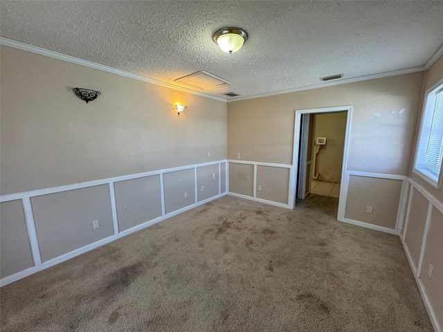 30147 Holly Rd, Punta Gorda, FL 33982 - carpeted spare room featuring a textured ceiling, visible vents, a decorative wall, ornamental molding, and attic access