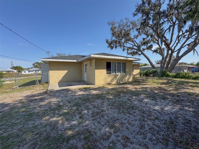 30147 Holly Rd, Punta Gorda, FL 33982 - back of property featuring stucco siding and fence