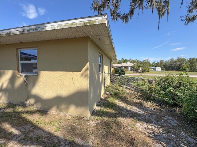 30147 Holly Rd, Punta Gorda, FL 33982 - view of side of property with stucco siding and fence