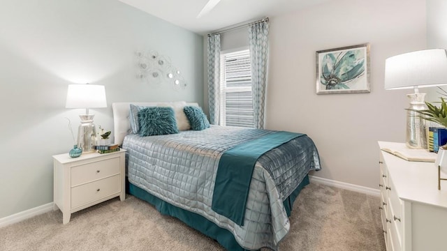 bedroom featuring baseboards and light carpet