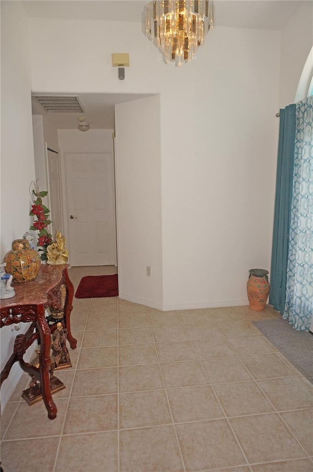 dining room with an inviting chandelier, light tile patterned floors, and visible vents