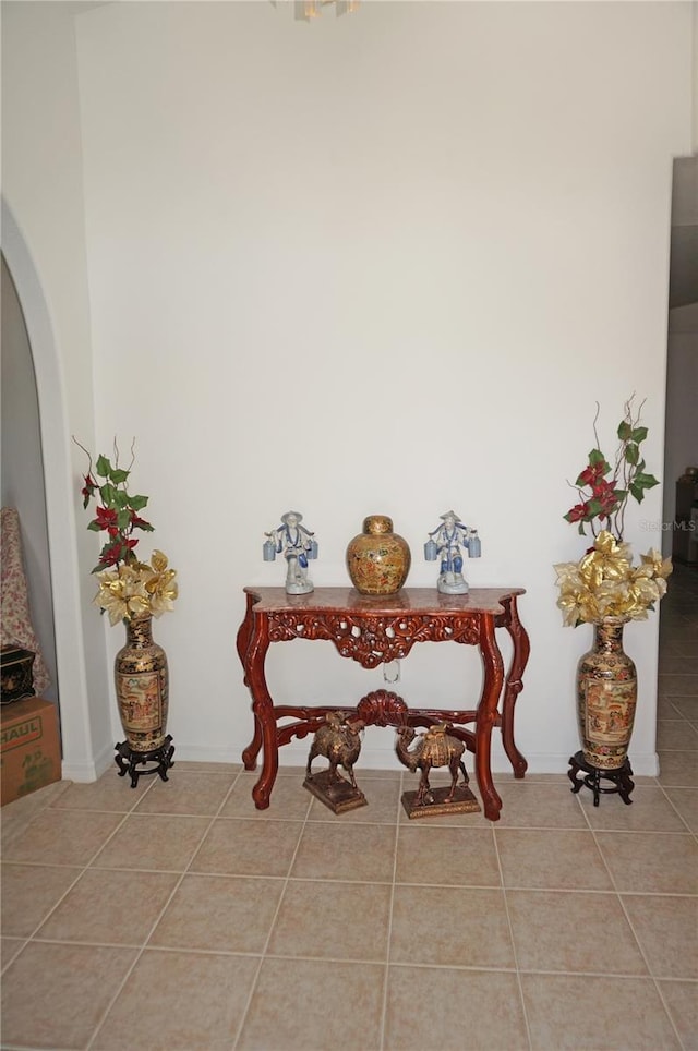 tiled dining room featuring arched walkways