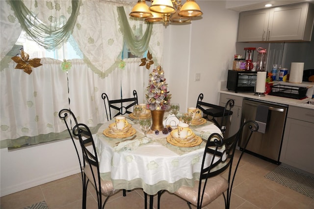 dining space with light tile patterned floors and a chandelier