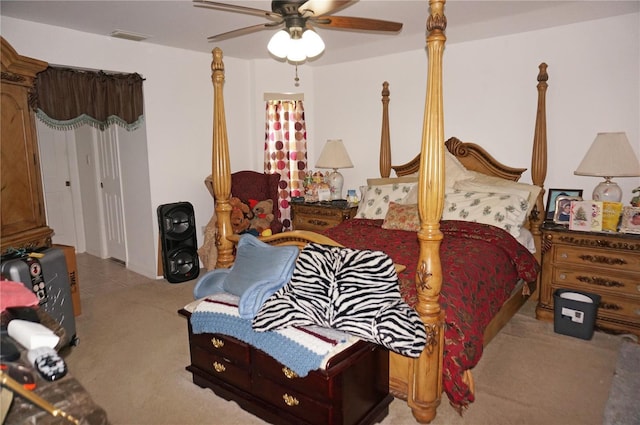 carpeted bedroom with a ceiling fan and visible vents