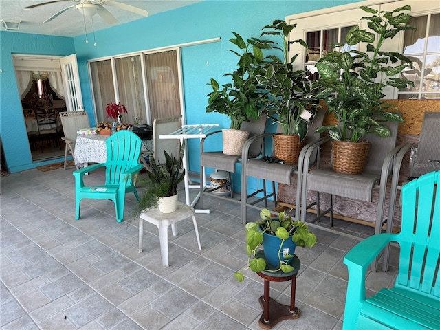 view of patio with a ceiling fan and visible vents