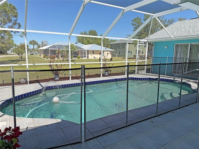 pool featuring a lanai, a yard, a patio area, and a residential view