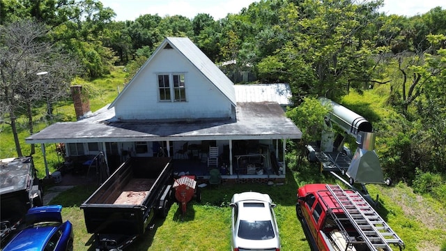 view of front of property featuring a view of trees and a chimney