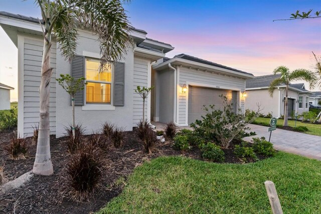 14381 Heritage Landing Blvd, Punta Gorda, FL 33955 - view of front of house with a front yard, a garage, and driveway