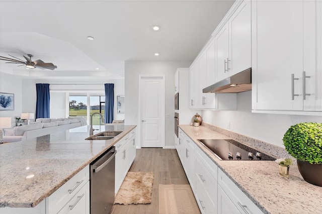 14381 Heritage Landing Blvd, Punta Gorda, FL 33955 - kitchen featuring under cabinet range hood, a sink, white cabinetry, recessed lighting, and stainless steel appliances