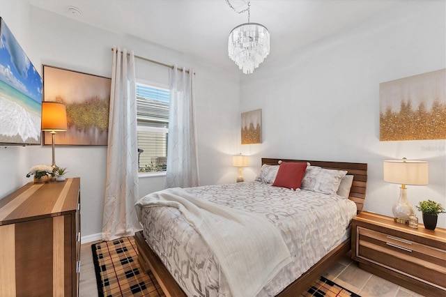 14381 Heritage Landing Blvd, Punta Gorda, FL 33955 - bedroom with baseboards, an inviting chandelier, and wood finished floors
