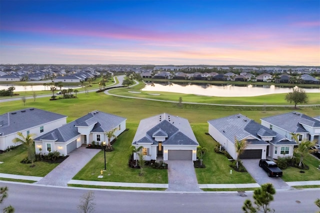 14381 Heritage Landing Blvd, Punta Gorda, FL 33955 - aerial view at dusk with a residential view, golf course view, and a water view