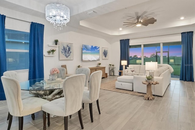 14381 Heritage Landing Blvd, Punta Gorda, FL 33955 - dining area with visible vents, ceiling fan with notable chandelier, wood finished floors, recessed lighting, and a raised ceiling