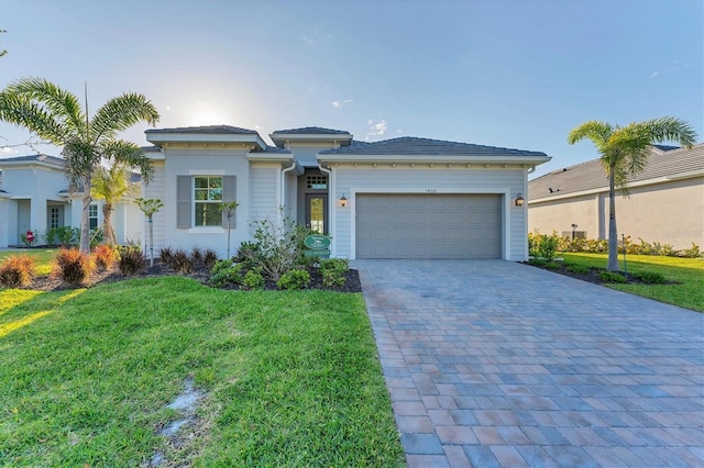 14381 Heritage Landing Blvd, Punta Gorda, FL 33955 - view of front facade with a front yard, decorative driveway, and a garage