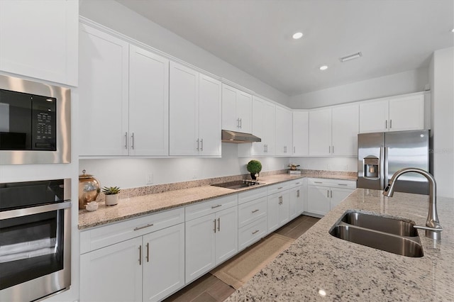 14381 Heritage Landing Blvd, Punta Gorda, FL 33955 - kitchen featuring white cabinetry, under cabinet range hood, appliances with stainless steel finishes, and a sink