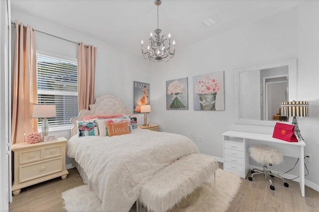 14381 Heritage Landing Blvd, Punta Gorda, FL 33955 - bedroom featuring wood finish floors, baseboards, and an inviting chandelier