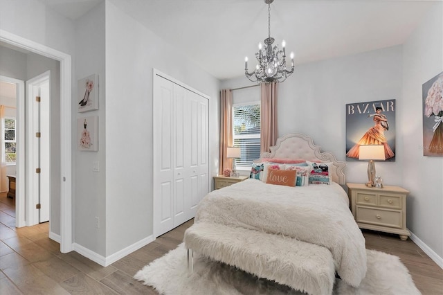 14381 Heritage Landing Blvd, Punta Gorda, FL 33955 - bedroom with a chandelier, baseboards, a closet, and wood finished floors