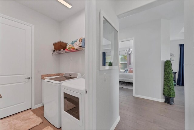 14381 Heritage Landing Blvd, Punta Gorda, FL 33955 - laundry area with laundry area, baseboards, light wood-type flooring, and washing machine and clothes dryer