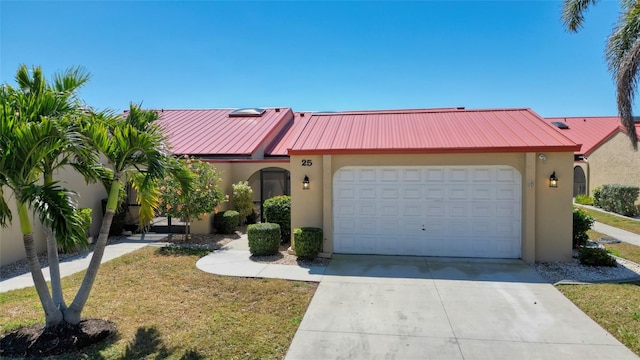 view of front of house with concrete driveway, stucco siding, metal roof, a garage, and a standing seam roof