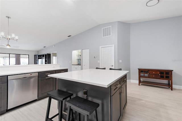 kitchen with visible vents, light wood-style flooring, light countertops, lofted ceiling, and dishwasher