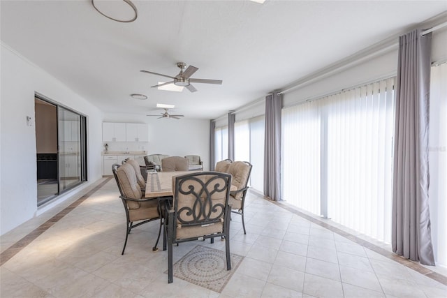 dining space featuring light tile patterned floors and ceiling fan