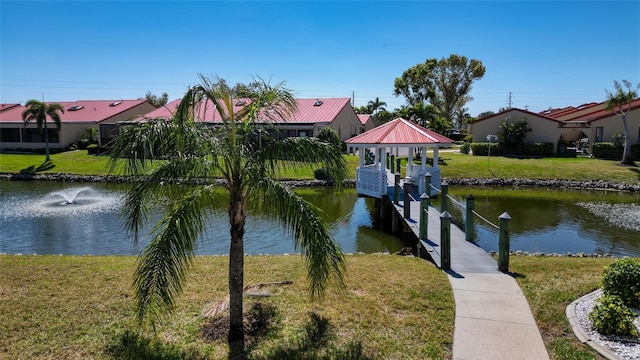 view of dock featuring a yard and a water view