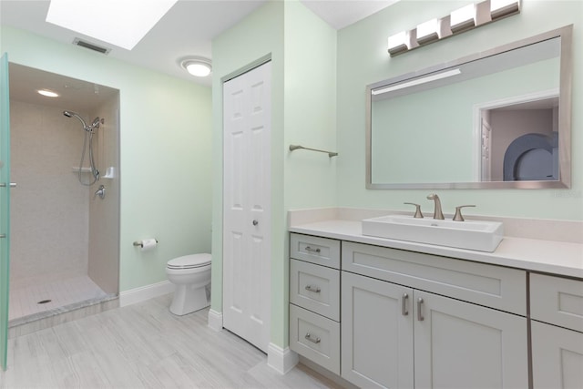 bathroom with vanity, visible vents, and a tile shower